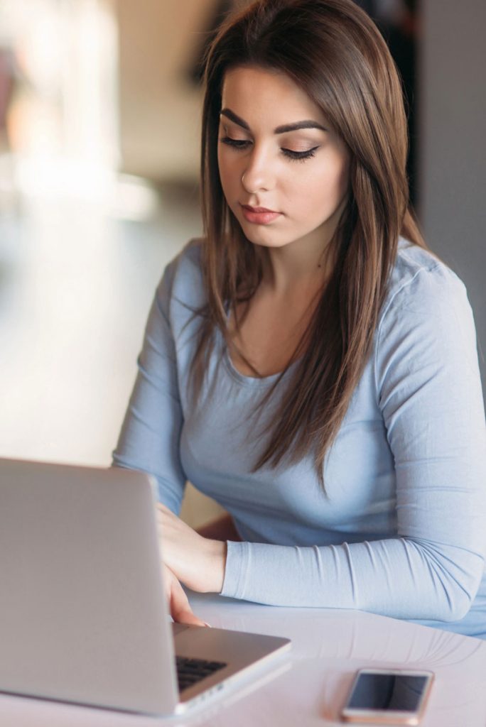 Young brunette looking at her computer